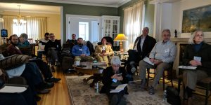 A room with people watching a presentation.